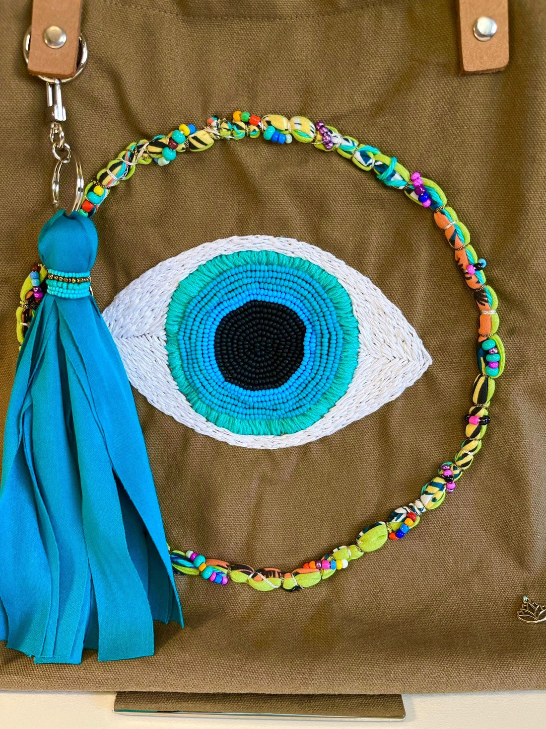 Mexoul Fabric hand bag with embroidered eye and tassel